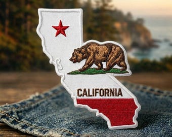 May include: An embroidered patch shaped like the state of California. The design features a white background, a red star in the upper left, a brown grizzly bear walking on a green patch of grass, and the word CALIFORNIA in brown text above a red stripe.