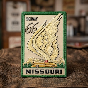 May include: A rectangular embroidered patch with a green border on a beige background. It features the text HIGHWAY 66 at the top and MISSOURI at the bottom. A large yellow wing extends upward from a yellow vintage convertible car graphic.