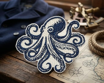 May include: Embroidered octopus patch in navy blue and cream. The octopus design features detailed tentacles and is set against a cream background. The patch is placed on a wooden surface with nautical-themed items, including a map and rope.