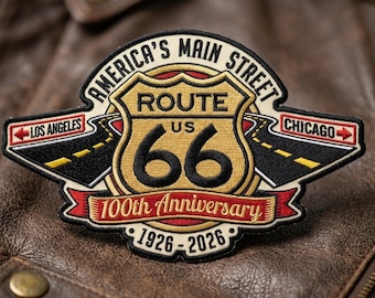 May include: Embroidered patch featuring the Route 66 logo with the text "America's Main Street." The patch commemorates the 100th anniversary from 1926-2026. The design includes the words "Los Angeles" and "Chicago" with directional arrows.