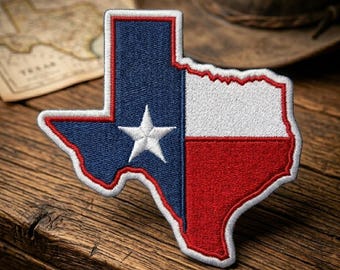 May include: An embroidered patch shaped like the state of Texas, featuring the design of the Texas state flag with a vertical blue stripe, a white star, and horizontal white and red stripes, all outlined with a thin red border.