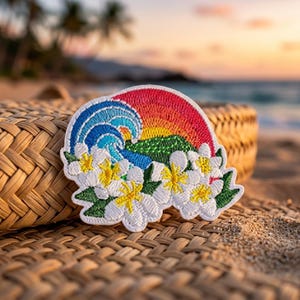 May include: An embroidered patch featuring a vibrant sunset with red, orange, and yellow hues, a blue ocean wave, and a cluster of white plumeria flowers with yellow centers. The patch has a scalloped edge and detailed thread work throughout.
