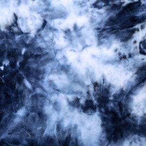 May include: Abstract tie-dye pattern in shades of blue and white. The fabric has a swirling, marbled effect.