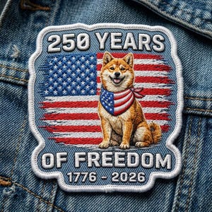 May include: Embroidered patch featuring a Shiba Inu dog wearing a patriotic bandana, set against a distressed American flag. The patch reads "250 YEARS OF FREEDOM 1776-2026" in white lettering, with a white border. The patch is on a denim background.