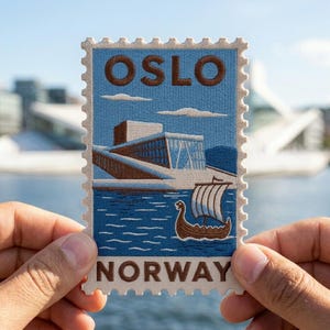 May include: A rectangular embroidered patch shaped like a postage stamp featuring the text OSLO at the top and NORWAY at the bottom. The design depicts a modern building with brown and white details situated by blue water with a small brown Viking ship.