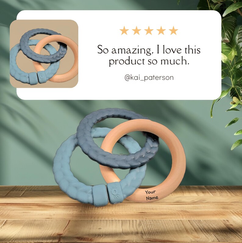 May include: Three interlocking teething rings in shades of blue and peach, resting on a wooden surface. The rings have a textured design and are connected with a clasp. The image includes text that says "So amazing. I love this product so much."
