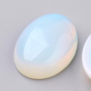 May include: A smooth, oval-shaped, white opal cabochon with iridescent rainbow colors.