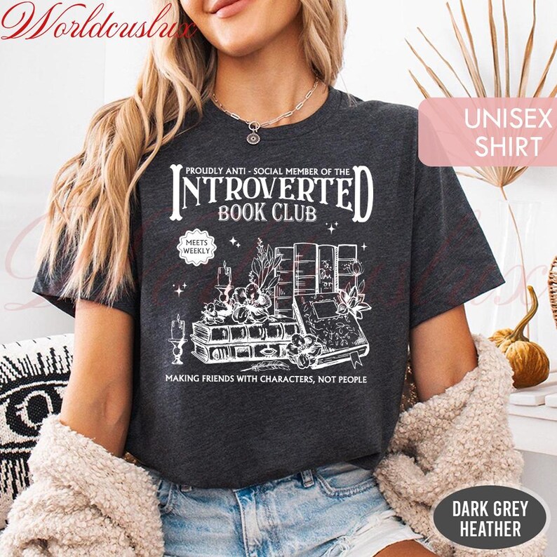 May include: Dark grey heather unisex shirt with the text "INTROVERTED BOOK CLUB" and a graphic of books, candles, and plants. The shirt reads "MAKING FRIENDS WITH CHARACTERS, NOT PEOPLE".