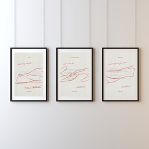 May include: Three framed art prints with black frames hang on a white wall. Each print features red line art and text on a cream background. The prints have different phrases and abstract illustrations.