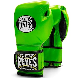 May include: Pair of bright green boxing gloves with black accents. The gloves feature the "CLETO REYES" logo in white and black, with "HECHO EN MEXICO" printed below. The gloves are designed for professional use.