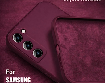 May include: Burgundy liquid silicone phone case for the Samsung S22 series. The case is shown in two parts, with the text "Liquid Silicone" and "For SAMSUNG S22 series" visible. The case has a soft, matte finish and is designed to protect the phone.