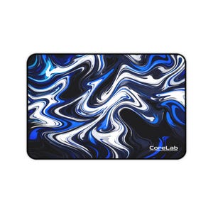 May include: Rectangular mousepad with a swirling abstract design in shades of blue, white, and black. The CoreLab logo is in the bottom right corner. The design resembles marble or liquid paint.