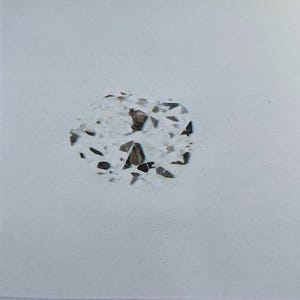 May include: A close-up of a diamond with a complex, irregular shape. The diamond has numerous facets, reflecting light and creating a sparkling effect. The stone is set against a white background. The text at the bottom reads: "The pictures shown above do not accurately represent the item's actual dimensions and/or colors."