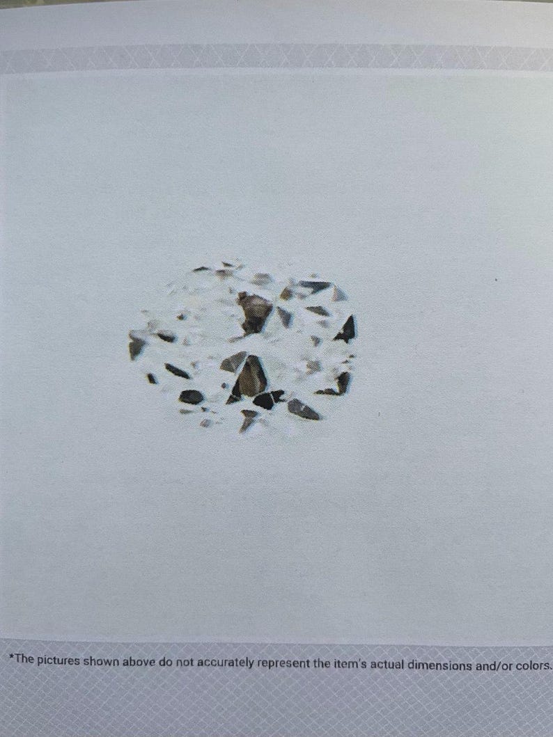 May include: A close-up of a diamond with a complex, irregular shape. The diamond has numerous facets, reflecting light and creating a sparkling effect. The stone is set against a white background. The text at the bottom reads: "The pictures shown above do not accurately represent the item's actual dimensions and/or colors."