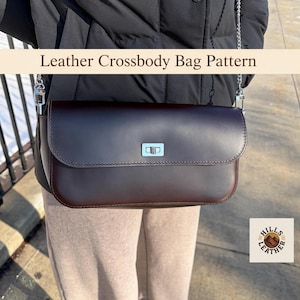 May include: A dark brown leather crossbody bag with a silver chain strap and clasp. The bag has a rectangular shape with a curved flap. The text "Leather Crossbody Bag Pattern" is displayed above the bag.