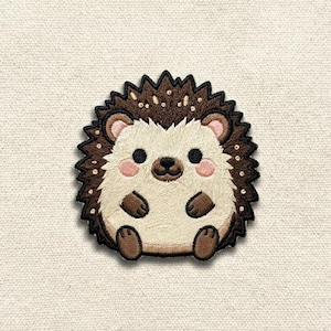 May include: Embroidered patch featuring a cute hedgehog design. The hedgehog has a cream-colored face and belly, with brown quills and small, dark eyes. The patch is outlined in a dark brown color and has a light beige background.