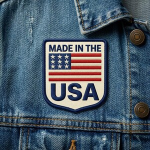 May include: Embroidered patch featuring the American flag with the text "MADE IN THE USA" in navy blue. The patch is rectangular with a white border and is sewn onto a denim jacket.