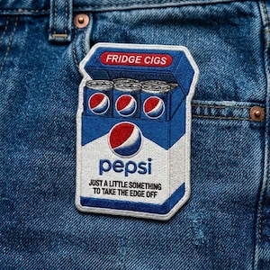 May include: Embroidered patch featuring a Pepsi-branded design. The patch depicts a blue and white cigarette box labeled "Fridge Cigs" with Pepsi cans inside. The text "Just a little something to take the edge off" is also included.