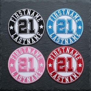 May include: Four circular patches with embroidered text. Each patch features the word "FIRSTNAME" and "LASTNAME" in a circular pattern around the number "21". The patches are in black, blue, pink, and red.