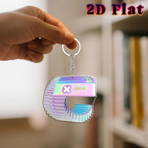May include: A holographic keychain with a layered design, featuring a computer error message. The keychain has a silver chain and ring. The text "2D Flat" is in the upper right corner.