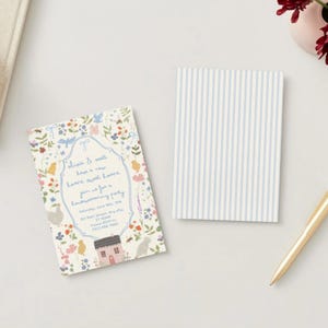 May include: A housewarming party invitation with floral and bird illustrations, featuring the text "Welcome & well, love a new home, sweet home". A matching notepad with blue and white vertical stripes and a gold pen are also present.