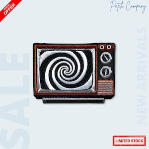 May include: Embroidered patch featuring a retro television design. The TV has a black and white spiral pattern on the screen, with a brown and black frame. The patch includes the text "LIMITED STOCK" in a red rectangle.