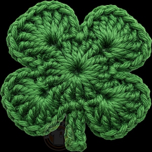 May include: A handmade, green crocheted shamrock with four leaves. The clover is made with a textured stitch, and the image is set against a black background. Ideal for St. Patrick's Day decorations or craft projects.