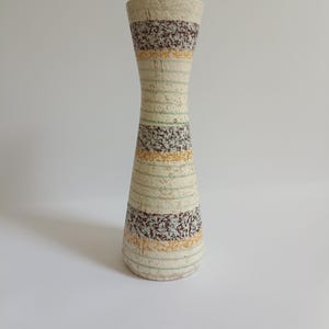 Può includere: Una tazza di ceramica bianca con manico nero e la scritta "But First, Coffee" in nero, in grassetto. La tazza è su una superficie bianca.