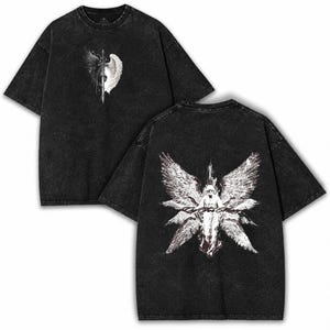 May include: A black acid-wash t-shirt featuring a front graphic of a sword between a black and white wing. The back displays a large white graphic of a winged figure with multiple sets of wings and script text centered below the figure.