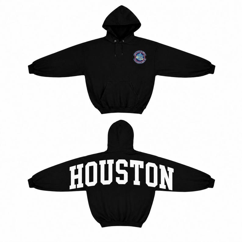 May include: A black hooded sweatshirt featuring a front kangaroo pocket and long sleeves. The front chest displays a circular NASA-style emblem, while the back features the word HOUSTON printed in large, bold, white capital block lettering.