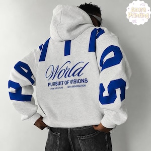 May include: A light grey hooded sweatshirt featuring bold blue lettering on the sleeves and back. The back displays the text World PURSUIT OF VISIONS PLAN THE FUTURE WITH IMAGINATION in a mix of script and block fonts, with blue accents.