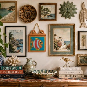 May include: A gallery wall featuring various framed landscape paintings, a woven basket, a sun-shaped wall plaque, a wooden fish carving, and a hanging tile with a fish illustration. Below, books, a ceramic pitcher, a bowl, and a brass bird figure.