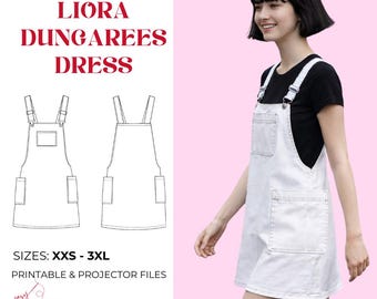 May include: A sewing pattern for the Liora Dungarees Dress, featuring sizes XXS to 3XL, printable and projector files. The image displays a white denim-style pinafore dress with a chest pocket, two side pockets, and adjustable shoulder straps.