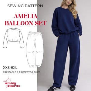 May include: A navy blue Amelia Balloon Set sewing pattern. The image shows a woman wearing a navy blue sweatshirt and matching pants. The pattern includes a diagram of the top and pants, with sizes XXS-6XL. The text "PRINTABLE & PROJECTOR FILES" is also visible.