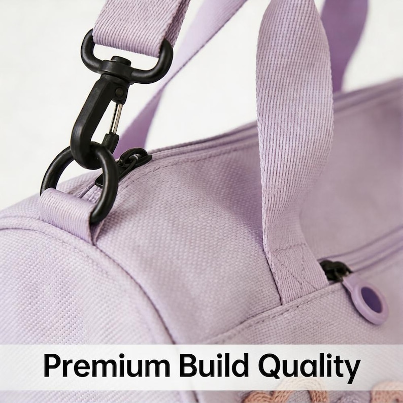 May include: Close-up of a lavender duffel bag with a black metal clasp and zipper. The bag has a matching lavender strap and the text "Premium Build Quality" is visible at the bottom.