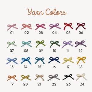 May include: A colour chart of yarn bows in various colours, including pink, blue, green, and yellow. Each bow is numbered, with the text "Yarn Colors" at the top. The bows are arranged in rows and columns, showcasing a wide range of yarn hues.