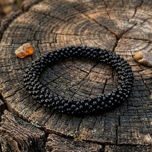 Pulsera hecha a mano con cuentas negras – Brazalete minimalista de cuerda tejida