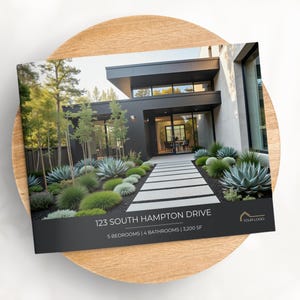 May include: A brochure featuring a modern home with a black exterior, a stone walkway, and lush landscaping. The brochure displays the address "123 South Hampton Drive" and property details. The brochure is placed on a wooden plate.