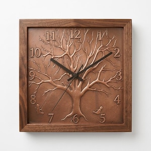 May include: Square wooden wall clock with a brown finish. The clock face features a detailed tree design with a textured, copper-colored background. Black clock hands and numbers are visible.