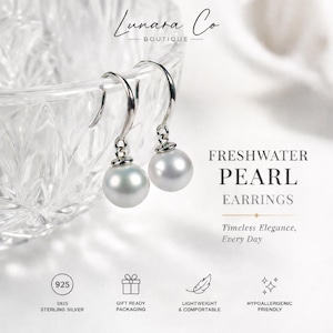 May include: Freshwater pearl earrings with sterling silver hooks. The earrings feature a large, round, white pearl. The image includes the text "FRESHWATER PEARL EARRINGS" and "Timeless Elegance, Every Day."