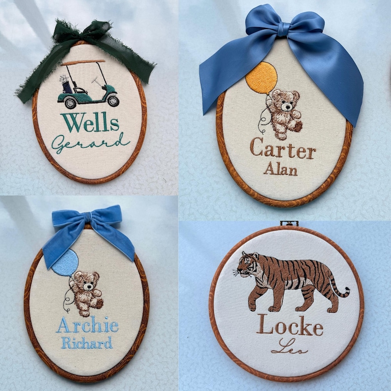 May include: Four embroidered wall hangings with wooden frames and bows. One features a golf cart and the name "Wells Gerard". Another shows a teddy bear with a balloon and the name "Carter Alan". A third has a teddy bear with a balloon and the name "Archie Richard". The last one depicts a tiger and the name "Locke Les".