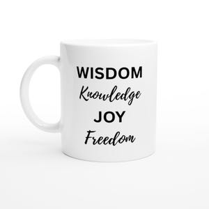 May include: White ceramic mug with a curved handle. The mug features the words "WISDOM, Knowledge, JOY, Freedom" in black, stylized lettering. The mug is designed for hot beverages.