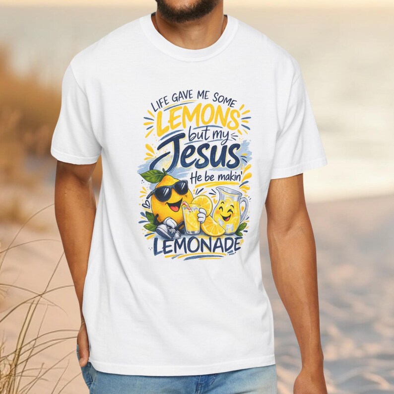 Man wearing Christian lemon shirt with “Life Gave Me Some Lemons But My Jesus He Be Makin’ Lemonade” graphic featuring cute lemon characters and faith message.
