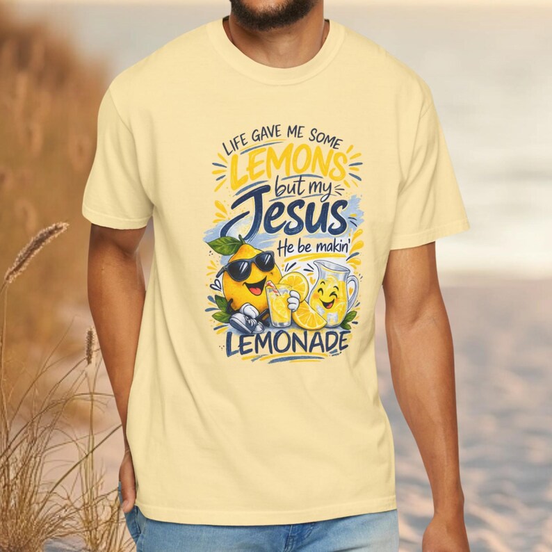 Man wearing Christian lemon shirt with “Life Gave Me Some Lemons But My Jesus He Be Makin’ Lemonade” graphic featuring cute lemon characters and faith message.