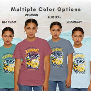 Funny Christian lemon shirt showing “Life Gave Me Some Lemons But My Jesus He Be Makin’ Lemonade” graphic tee available in sea foam, crimson, blue jean, and chambray colors.
