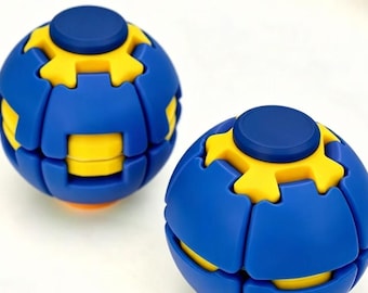 May include: Two spherical fidget puzzles featuring a blue and yellow interlocking gear design. Each sphere has a smooth blue surface with yellow accents and a central blue circular button on top, creating a mechanical look with segmented parts.