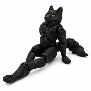 May include: A black wolf action figure with articulated joints, textured fur detailing, and bright yellow eyes. The figure is posed in a seated position with its legs extended forward and a long, bushy tail trailing behind it on the ground.