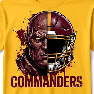 May include: A yellow t-shirt featuring a graphic of a football helmet and a stern-faced person. The helmet is maroon and gold, and the text "COMMANDERS" is printed in maroon at the bottom of the shirt.