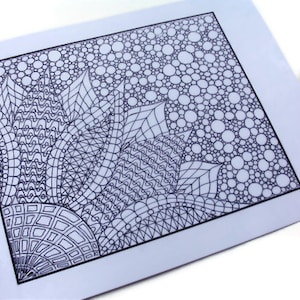 May include: Black and white adult coloring page with a floral design and bubble pattern. The page is accompanied by a set of red, yellow, green, and blue colored pencils, perfect for creative expression and relaxation.