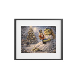 May include: A framed print featuring a whimsical illustration of a frog-like character in a white dress holding a nutcracker. The background shows a snowy forest with a Christmas tree and toy soldiers. The artwork has a fairytale theme.